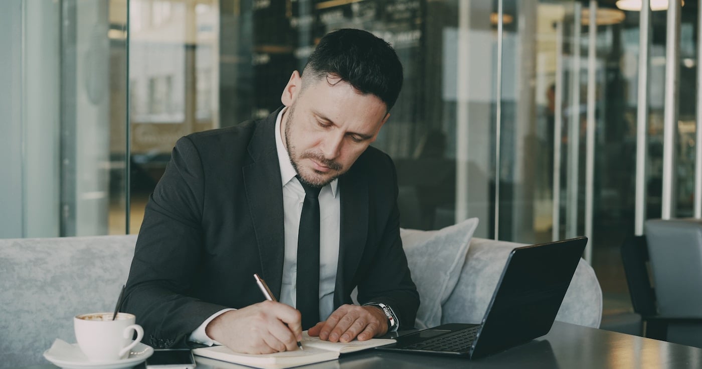 Business professional researching the buyer journey on a laptop
