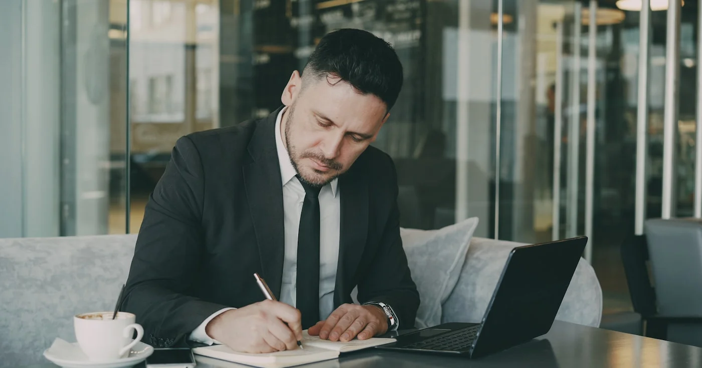 Business professional researching the buyer journey on a laptop